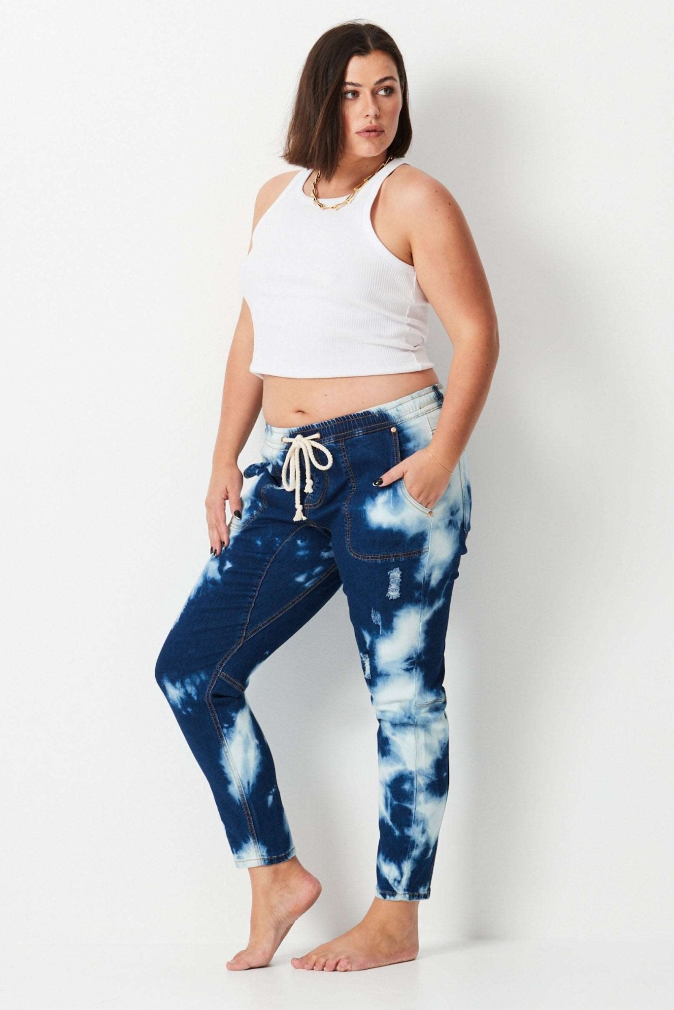 Shibori Keepers - Indigo Wash - 17 Sundays17 SundaysModel wears plus size dark blue tie dye denim jeans. with elastic waist and tapered leg.