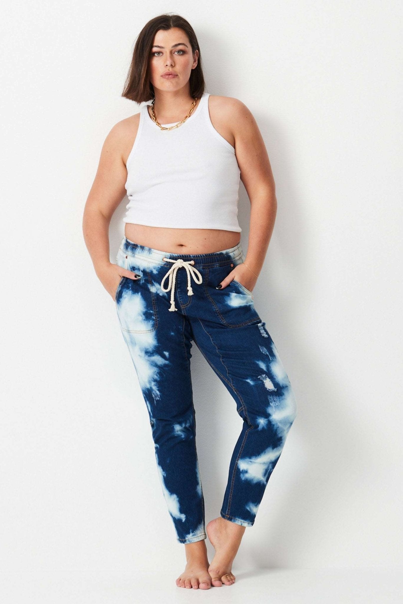 Shibori Keepers - Indigo Wash - 17 Sundays17 SundaysModel wears dark blue tie dyed stretch denim plus size jeans. with elastic waist and tapered leg.